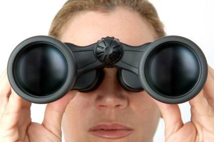Woman looking trhough binoculars