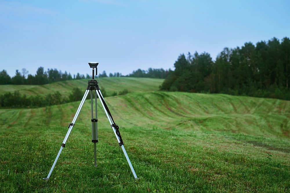 Image of tripod in field by Jeremy Bishop on Unsplash.