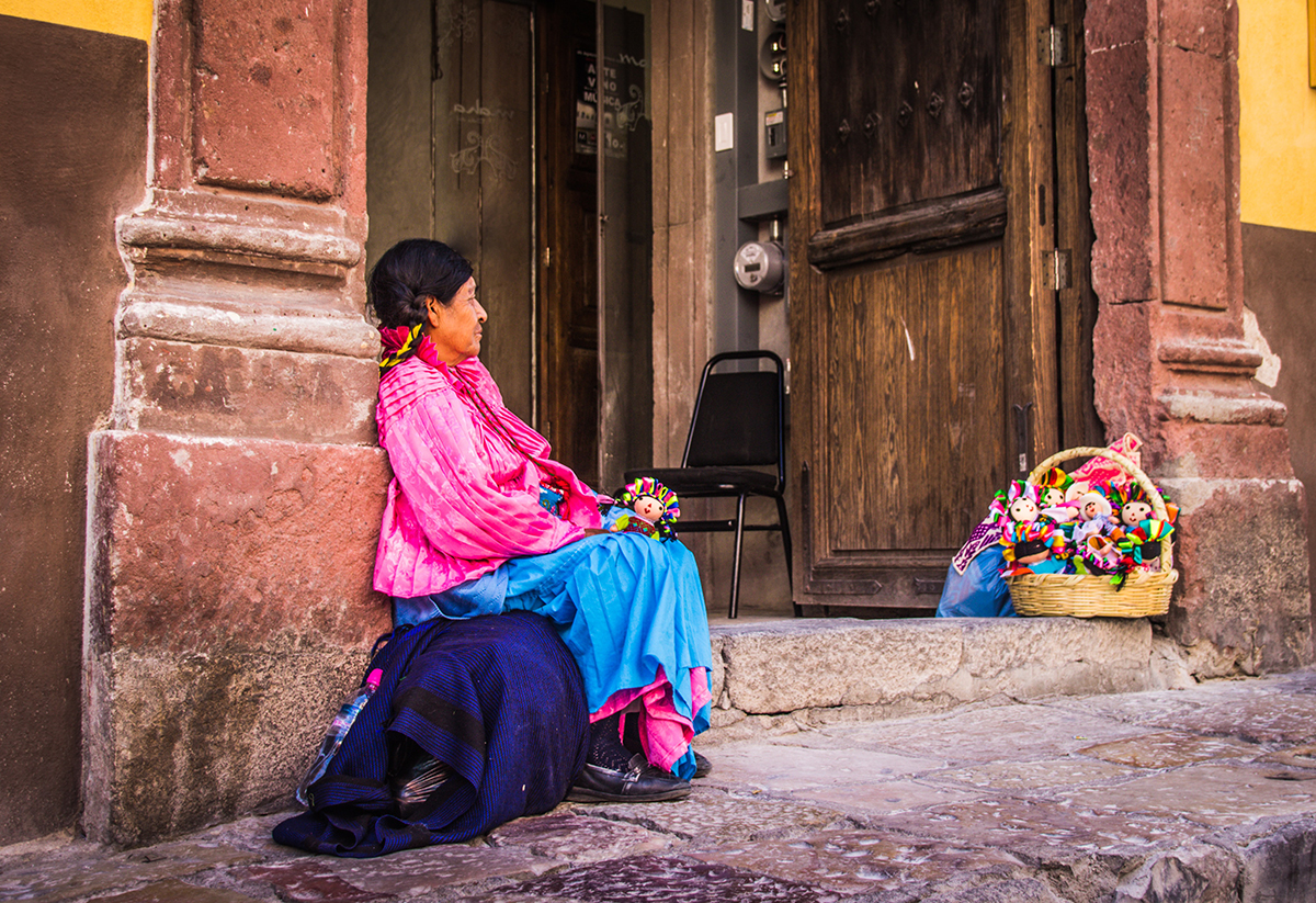 Indigenous American woman sitting in a doorway