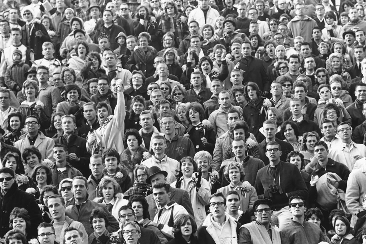 An audience of sports spectators cheering and observing a sporting event. (c.1950)