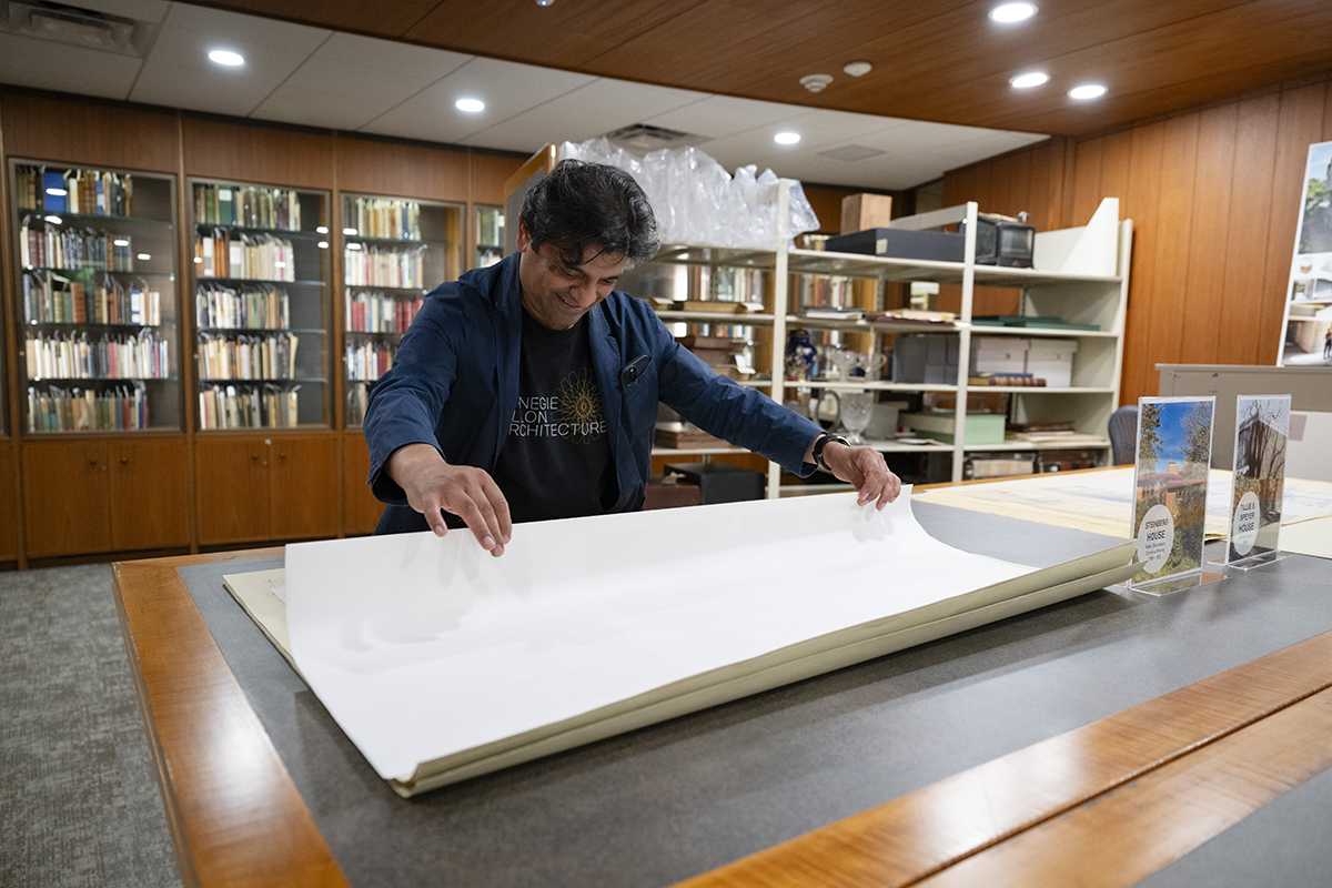 Head of the School of Architecture Omar Khan explores architectural drawings of the Steinberg house by Peter Berndtson and Cornelia Brierly on display. The Architecture Archives was founded as a collaborative project between the Libraries and the School of Architecture.