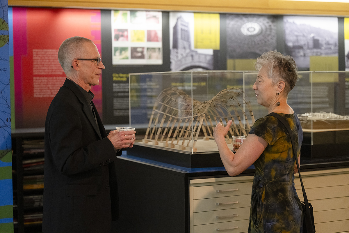 Aurand and his wife Joanne view a model of a bamboo gateway designed by National Organization of Minority Architecture Students (NOMAS) members from the School of Architecture for the 2023 Spring Carnival.
