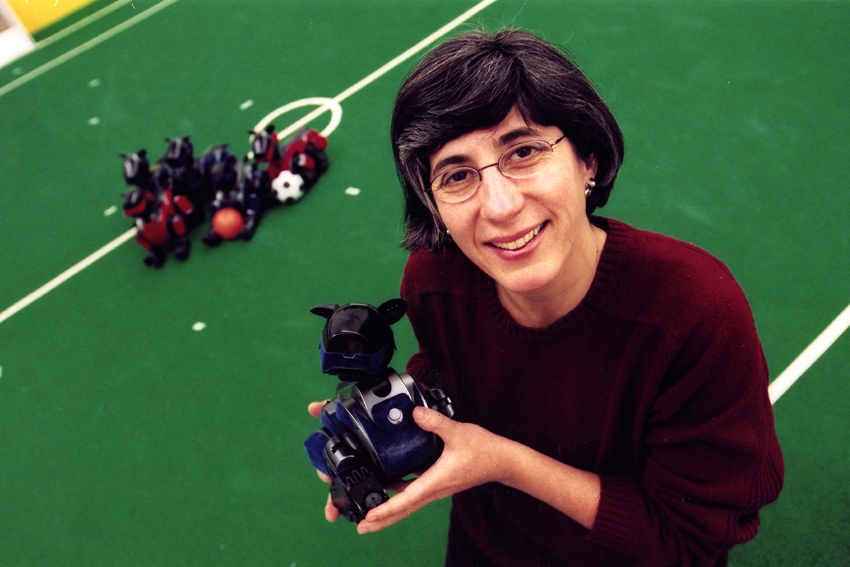 Dr. Manuela Veloso poses with one of the Sony AIBO robots she and her students used in RoboCup competitions. From the General Photograph Collection.