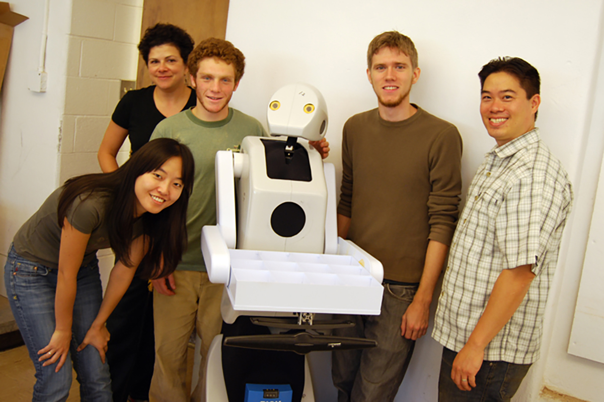 Dr. Jodi Forlizzi and members of the Snackbot team stand with an early version of the robot. From the Jodi Forlizzi Papers, 2021-0010.