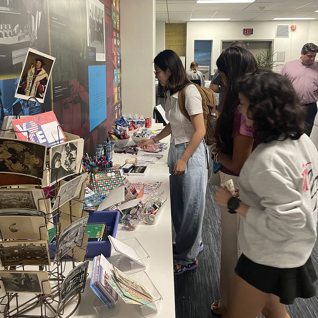 Attendees make use of a selection of crafting supplies, provided by Arts and Humanities Librarian Jill Chisnell, to make their postcards.