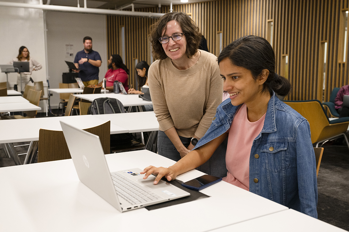 Librarian Sarah Young helps a student at a workshop