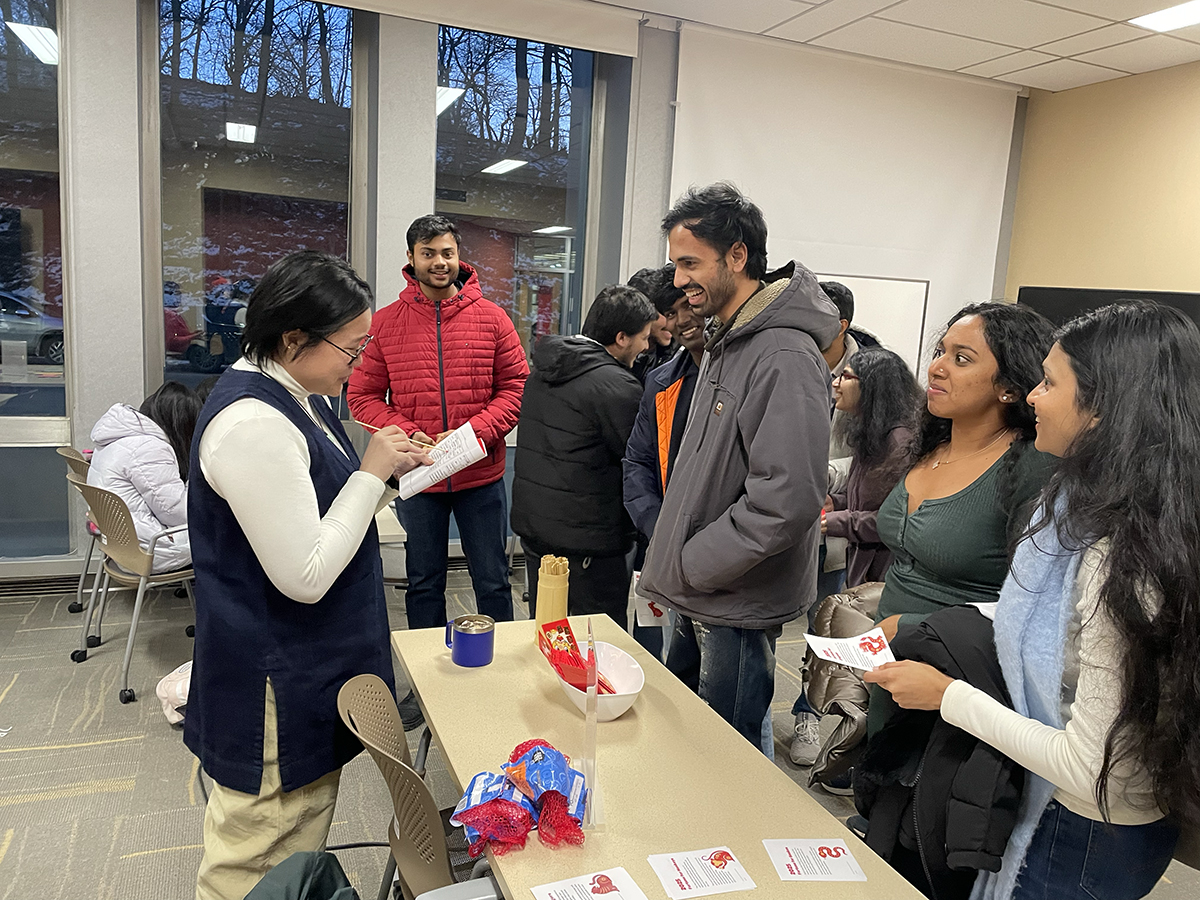 Social Sciences Librarian Di Yoong interprets fortunes for attendees.