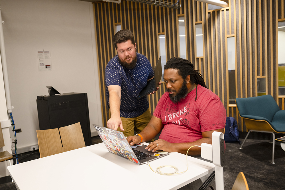 Chasz Griego helps a student