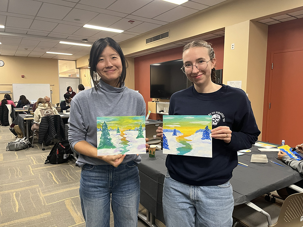 Attendees followed along to create one of several winter paintings, including this snowy sunset on a winding river.