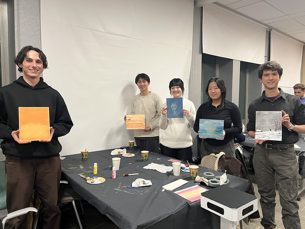 A group of students showcase their finished art.