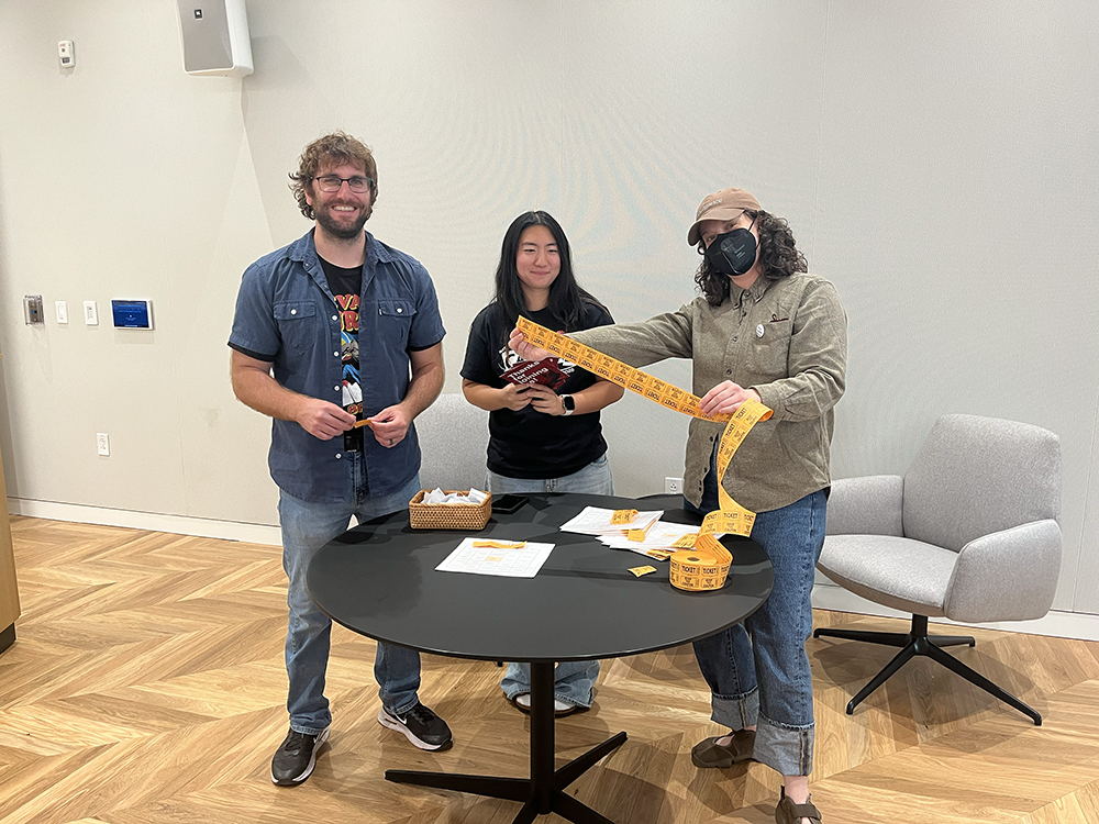 Checchio, College of Engineering first-year and Student Events Assistant Gianna Zhang, and Outreach and Engagement Manager Erin Swift get ready to pull the winning raffle tickets.