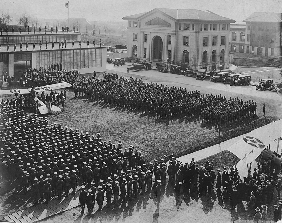Dedication of the Langley Aeronautical Laboratory, 1918. Langley Aeronautical Laboratory was built in just twenty-three working days to provide a space for soldiers to learn how to repair airplanes. The dedication featured remarks from local dignitaries troops in formation and planes driven across campus to be housed in the new building. The building was named for Samuel Langley an aviation pioneer and the first director of the Allegheny Observatory. World War I Records Carnegie Mellon University Archives.