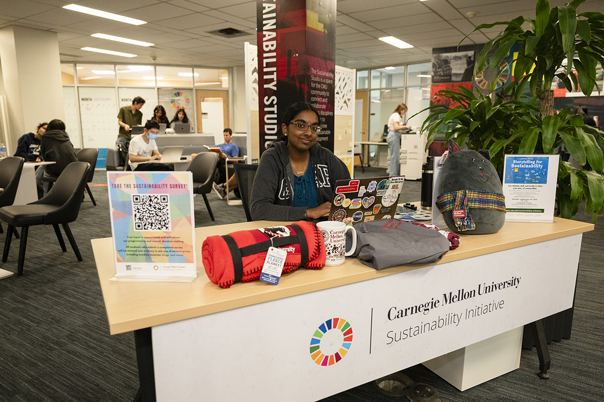 Student sits at front desk in the Sustainability Studio. Photo by Rebecca Devereaux.