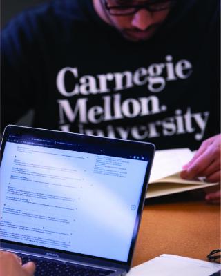 Image of CMU student using laptop.