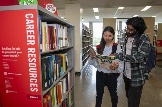 Students at the Career Services bookshelf