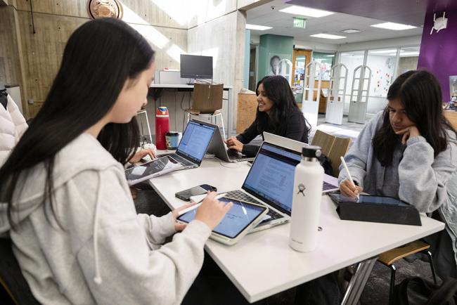 CMU students on laptops at the library